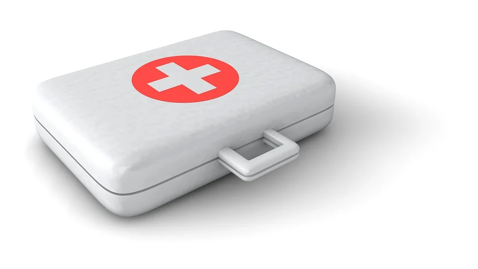 Weiße Erste-Hilfe-Box mit rotem Kreis und weißem Kreuz auf dem Deckel.